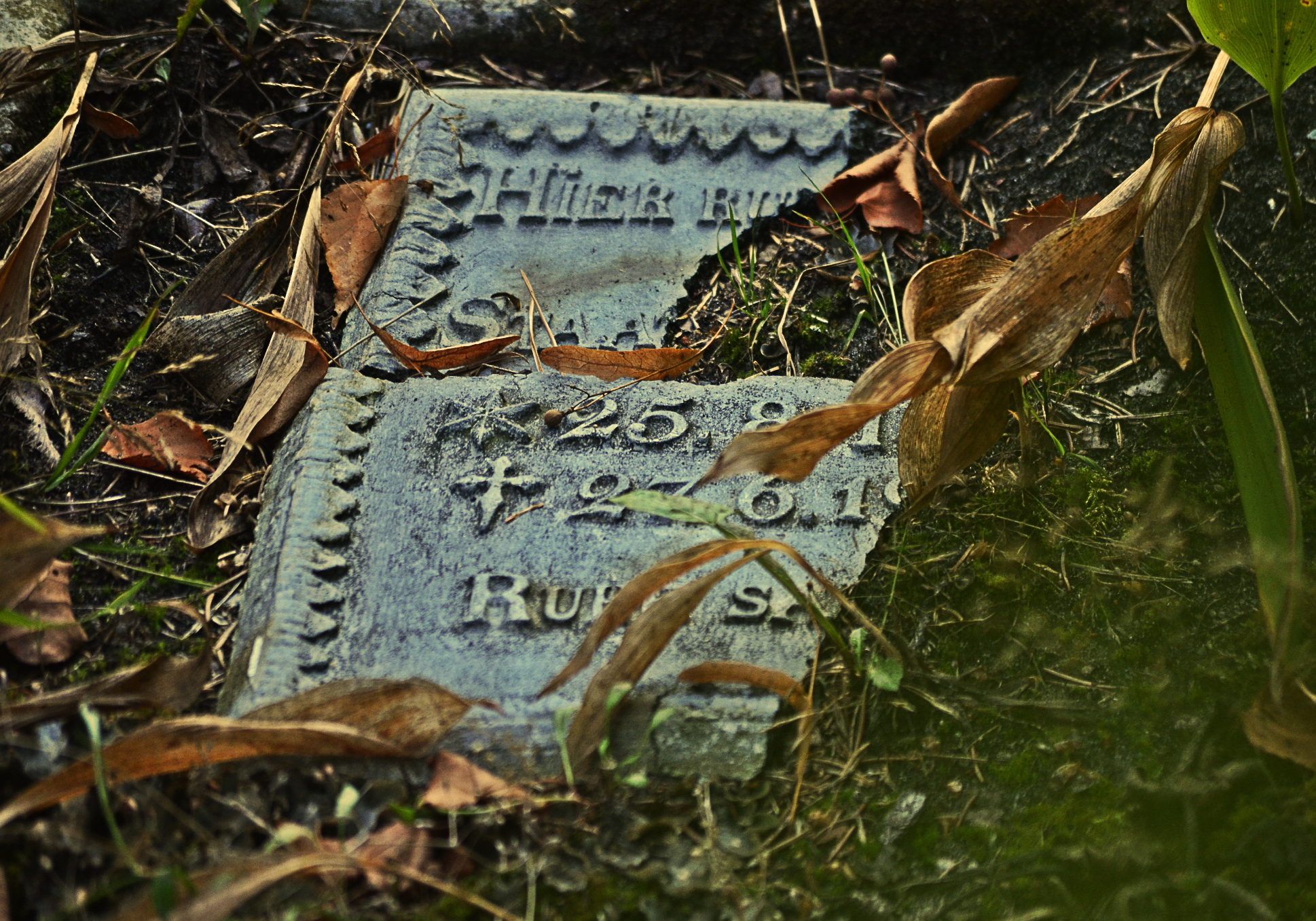 broken gravestone on the ground