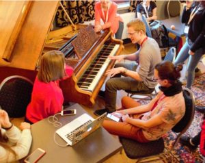 Participants of EUSTORY Summit 2018 playing the piano