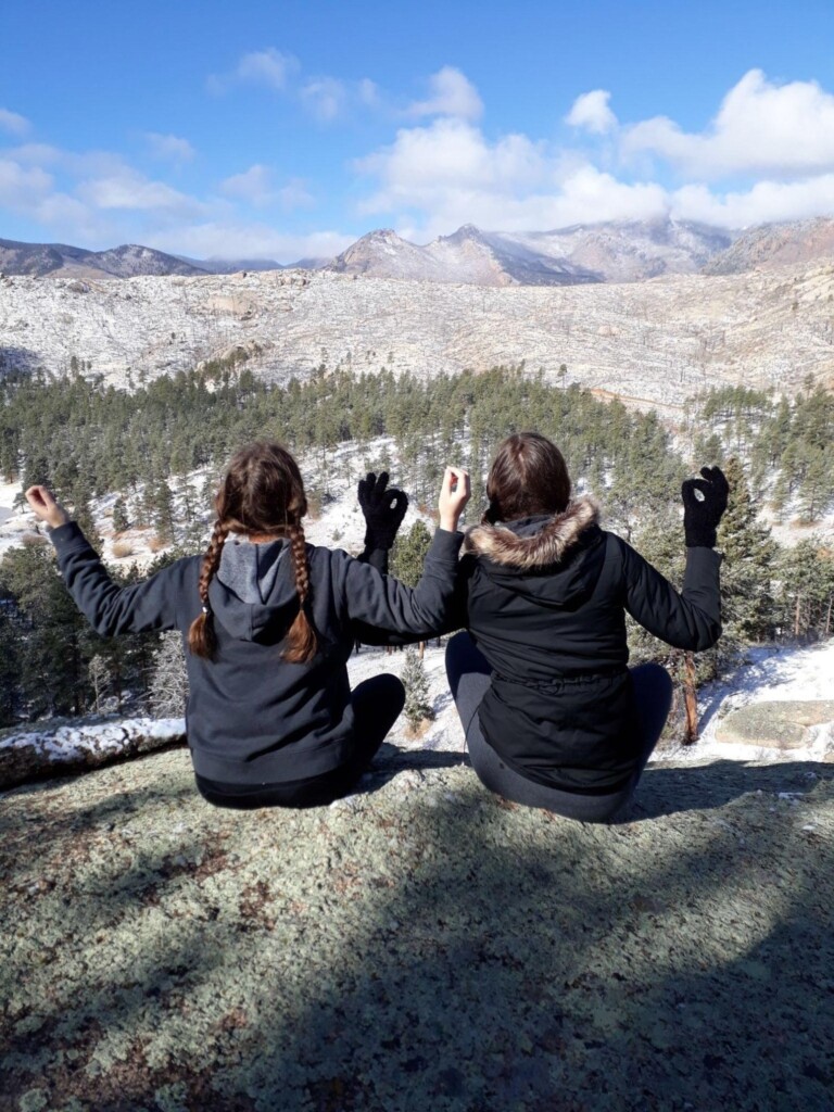 A new perspective on religion: Author and her friend praying in the Rocky Mountains.