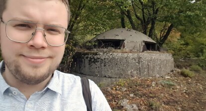 Gregor standing in front of a bunker in Albania.