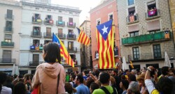 Catalans reunite in a local square for a demonstration, waving the pro-independence flags, called "esteladas".