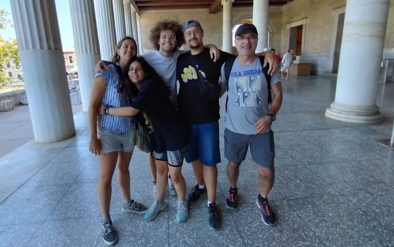 In the Athens Agora, the author Eva, the editor María and two fellow theatre group members pose for a photo with Pepe, the director.