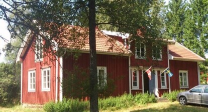 Red house in Sweden with Denmark's flag
